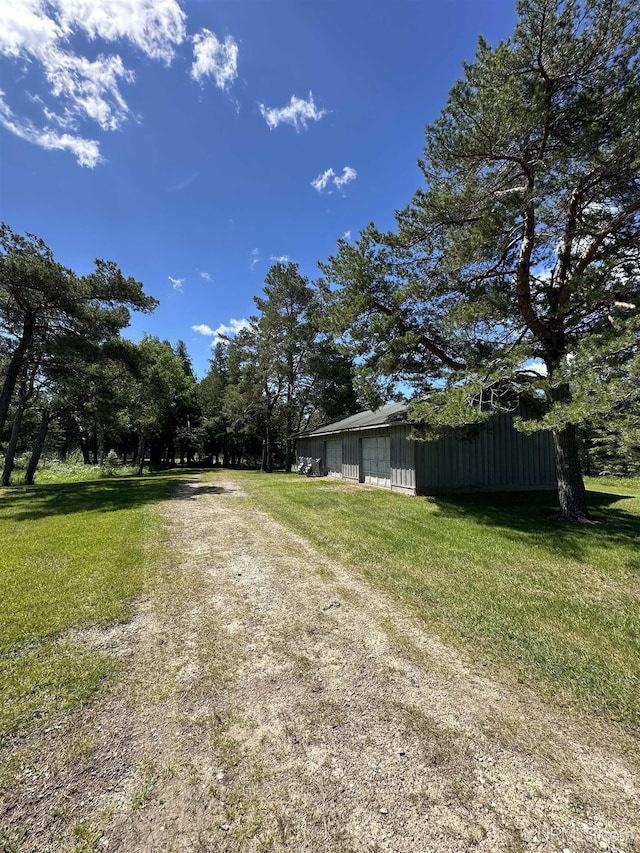 view of yard with dirt driveway