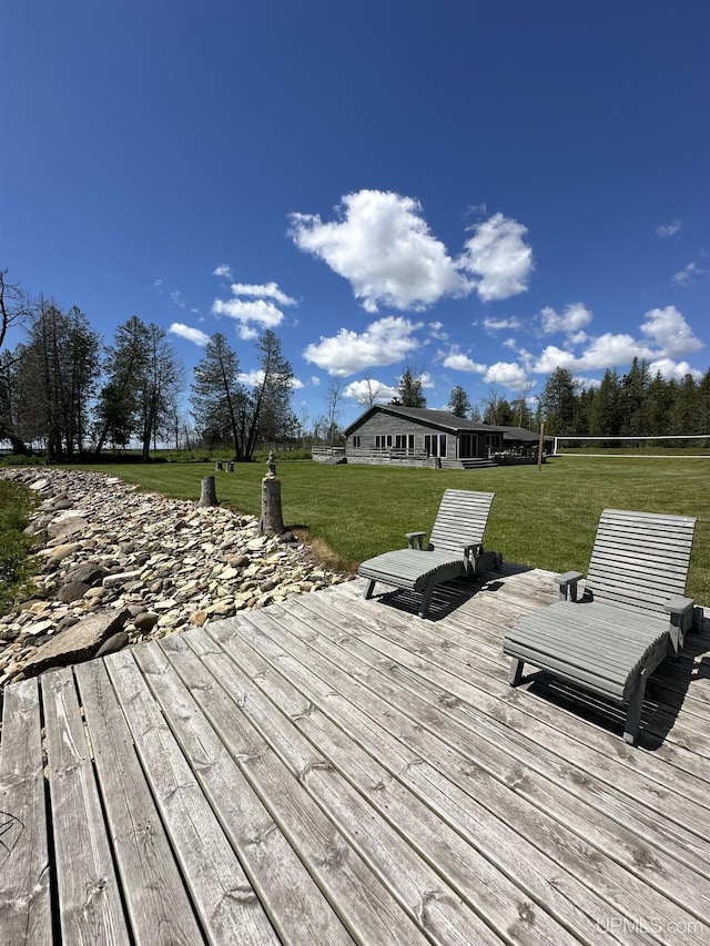 wooden deck featuring a yard