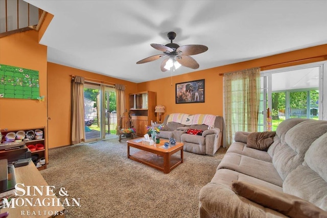 carpeted living room with ceiling fan