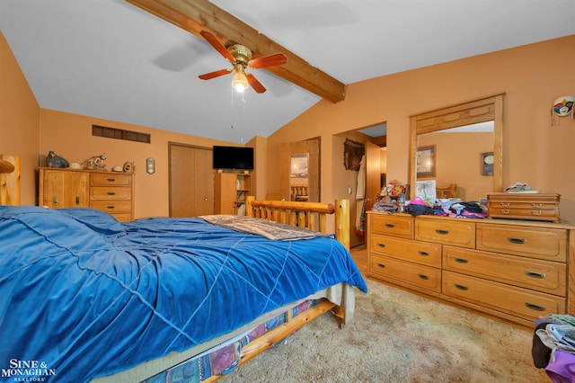 bedroom with ceiling fan, lofted ceiling with beams, light carpet, and a closet