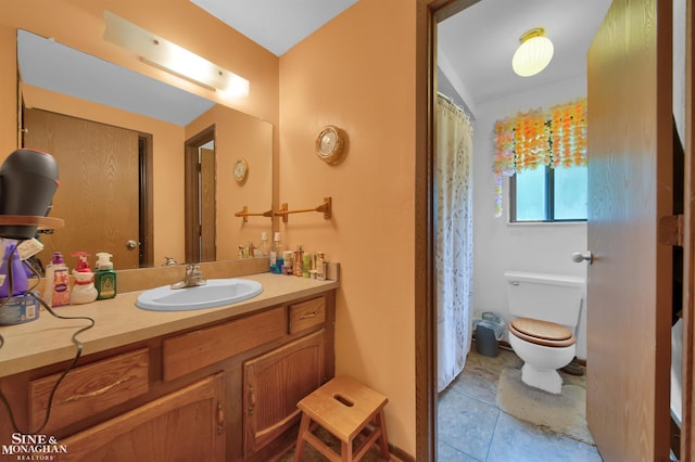 bathroom with tile patterned floors, vanity, and toilet