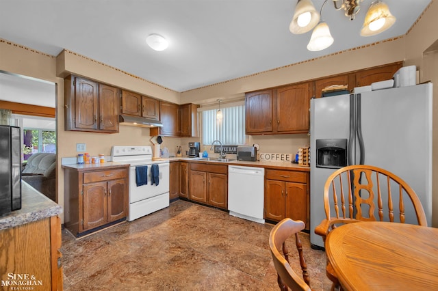 kitchen with decorative light fixtures, sink, a chandelier, and white appliances