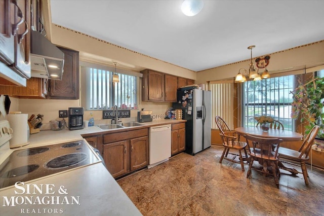 kitchen featuring stainless steel fridge with ice dispenser, dishwasher, a healthy amount of sunlight, and decorative light fixtures