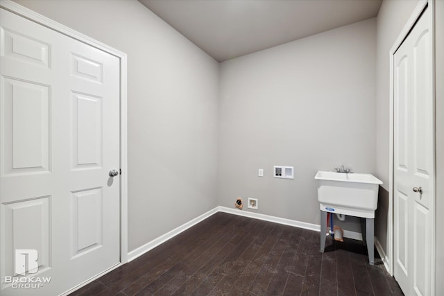 laundry area featuring dark wood-type flooring and washer hookup