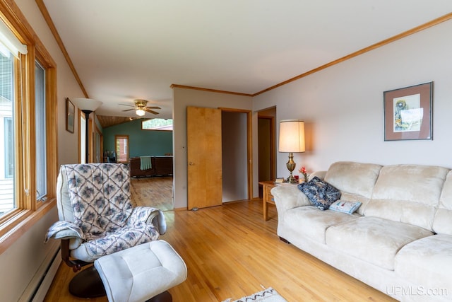 living room with baseboard heating, light wood-type flooring, ceiling fan, and crown molding