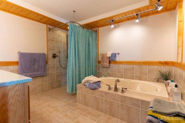 bathroom with tile patterned flooring, independent shower and bath, and vanity