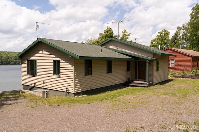 back of property featuring a yard