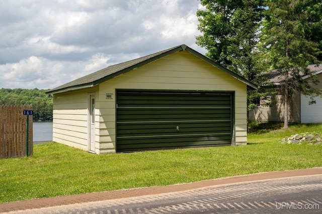 view of outbuilding with a garage and a yard