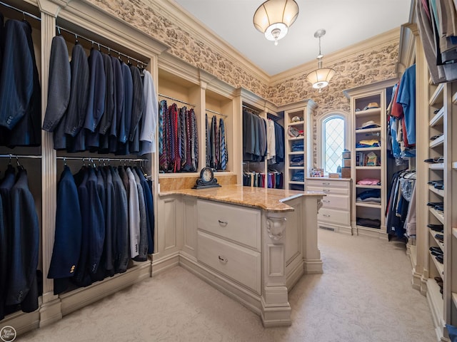 walk in closet with light colored carpet