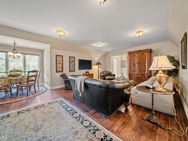 living room with vaulted ceiling, dark wood-type flooring, and a chandelier