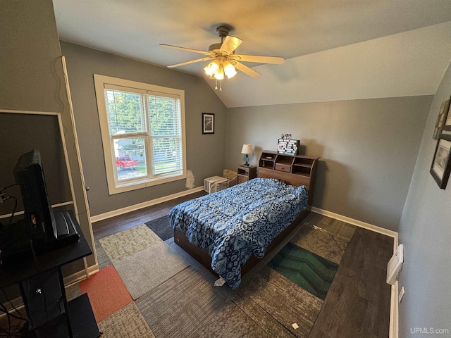 bedroom with ceiling fan, dark hardwood / wood-style floors, and lofted ceiling