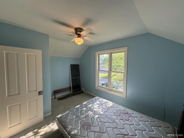 carpeted bedroom featuring ceiling fan and vaulted ceiling