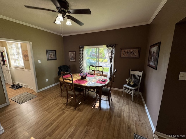 dining room with hardwood / wood-style flooring, ceiling fan, and ornamental molding