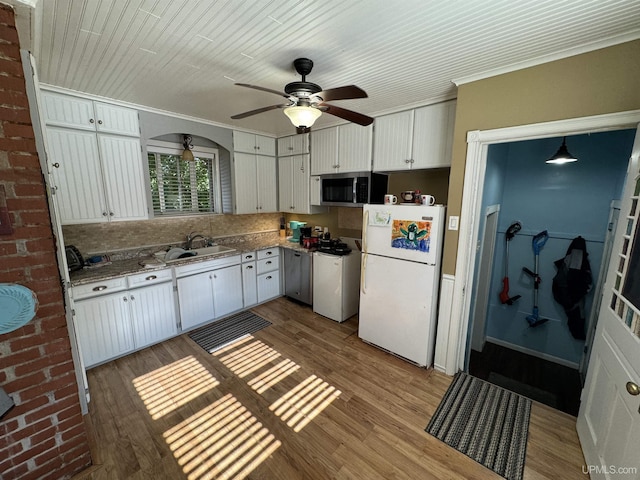 kitchen featuring range, light hardwood / wood-style flooring, white cabinets, and white refrigerator