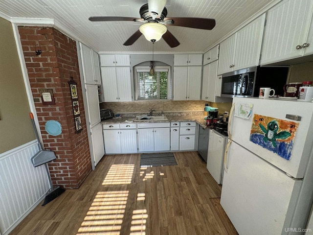 kitchen with white fridge, white cabinetry, dark hardwood / wood-style floors, and sink