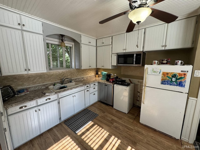 kitchen with white refrigerator, crown molding, sink, light hardwood / wood-style flooring, and white cabinetry