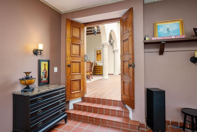 interior space with tile patterned flooring and ornate columns