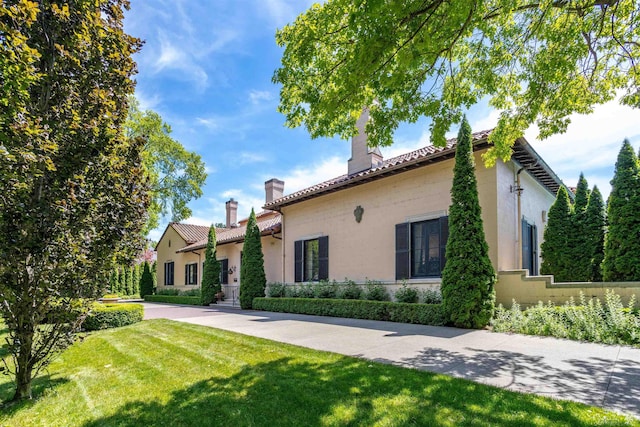 rear view of property featuring a lawn