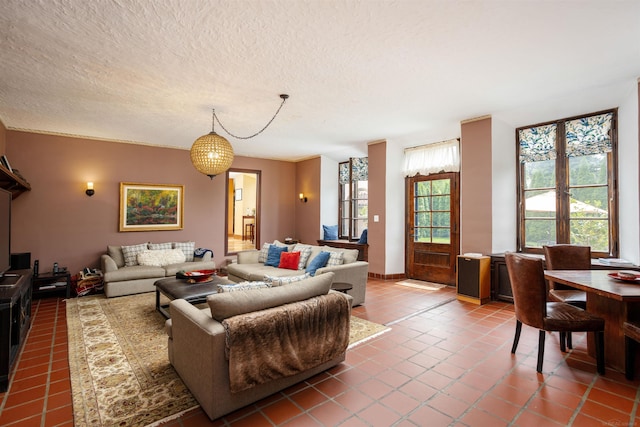 tiled living room featuring a textured ceiling