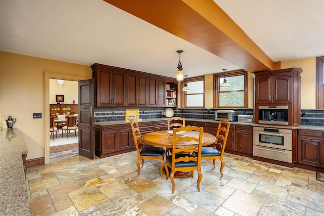 kitchen featuring backsplash, dark brown cabinetry, oven, and pendant lighting