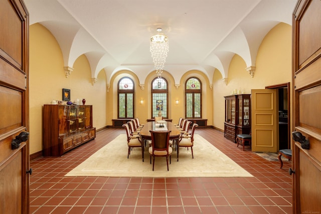 dining room featuring tile patterned floors and a notable chandelier