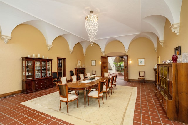 tiled dining space with a notable chandelier