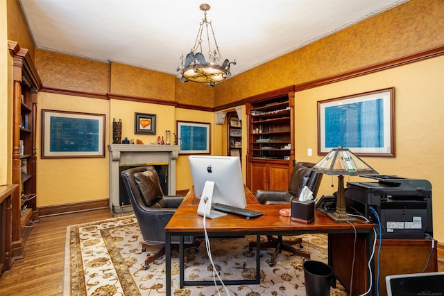 home office featuring a chandelier and hardwood / wood-style flooring