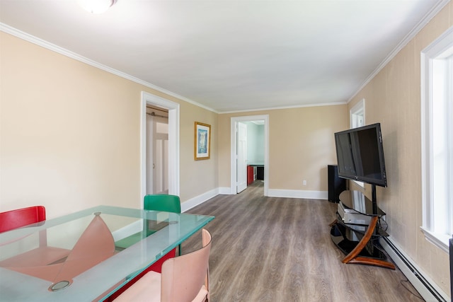 interior space featuring wood-type flooring, a baseboard heating unit, and ornamental molding