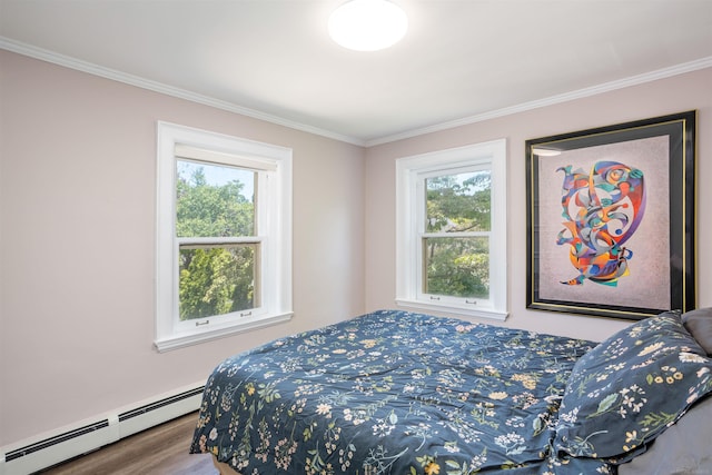 bedroom with baseboard heating, multiple windows, crown molding, and hardwood / wood-style floors