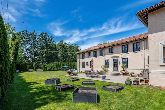 rear view of house featuring a patio and a lawn