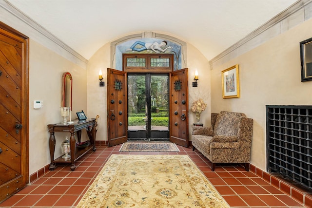 tiled foyer featuring vaulted ceiling