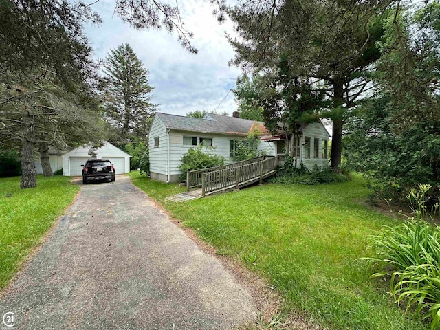 view of front facade with a deck, a front lawn, a garage, and an outdoor structure