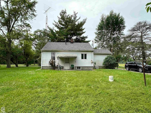 rear view of house with a lawn