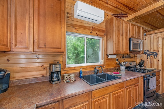 kitchen with a wall mounted air conditioner, black range with gas cooktop, sink, wooden ceiling, and wood walls