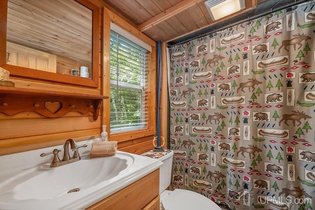 bathroom with vanity, toilet, curtained shower, and wooden ceiling