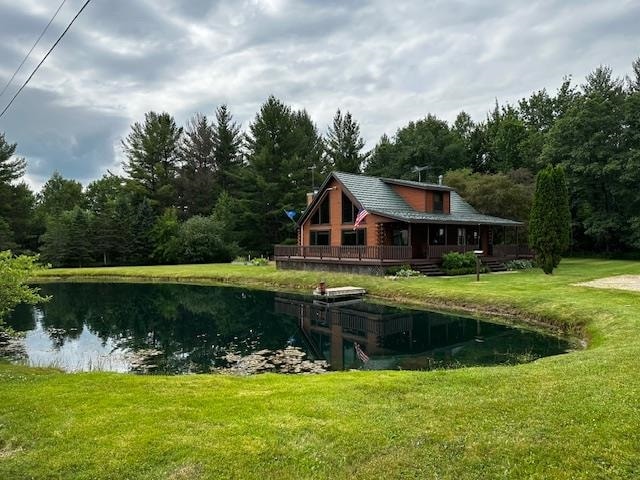 exterior space with a water view and a yard