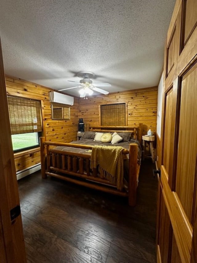 bedroom with wood walls, a baseboard radiator, ceiling fan, and dark hardwood / wood-style floors