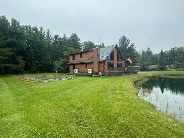 view of yard with a deck with water view