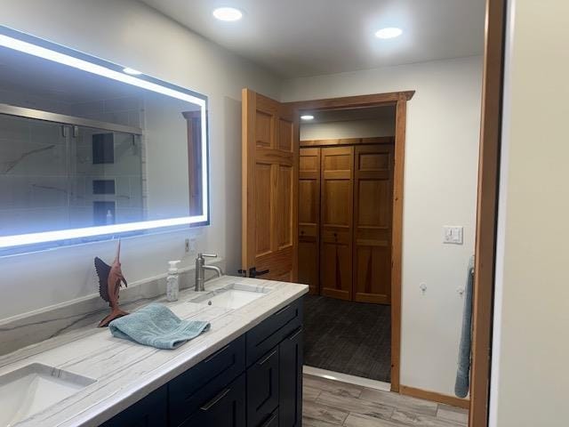 bathroom featuring dual vanity and hardwood / wood-style floors