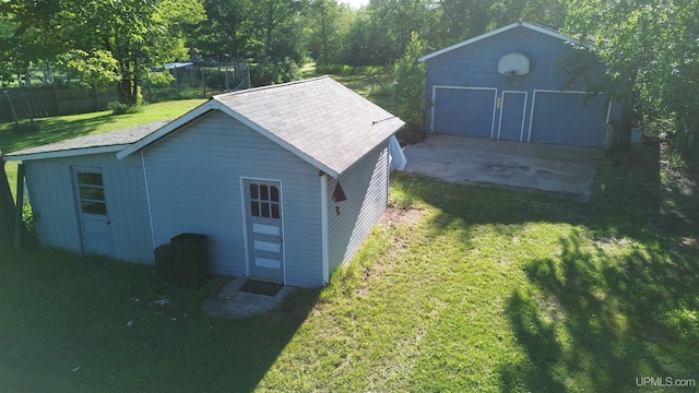 view of outbuilding featuring an outbuilding and fence