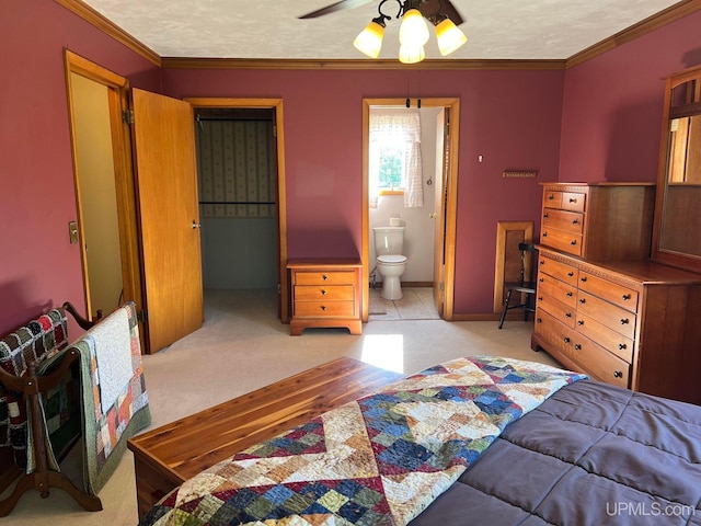 bedroom with light carpet, a textured ceiling, a walk in closet, and crown molding