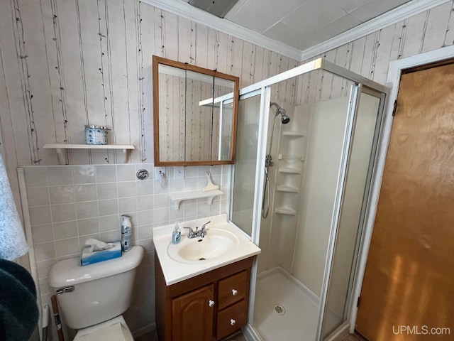 full bathroom featuring toilet, a stall shower, crown molding, and vanity