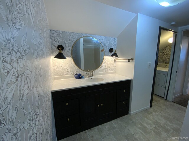 bathroom featuring tile flooring, vanity, and lofted ceiling