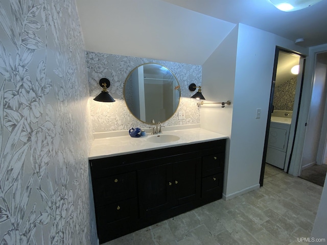 bathroom with vanity and washer / dryer