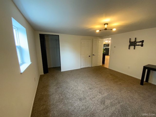 unfurnished bedroom featuring dark colored carpet