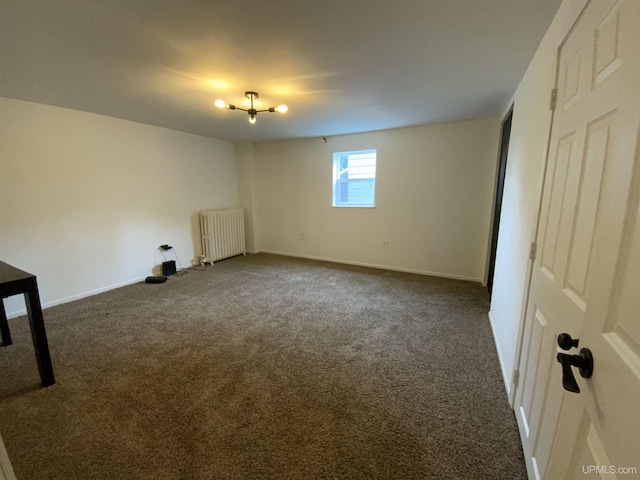 interior space with dark colored carpet, radiator heating unit, and baseboards