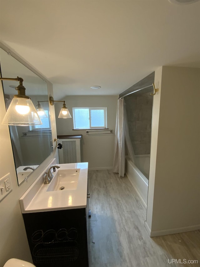 full bath with shower / bathtub combination with curtain, baseboards, wood finished floors, and vanity