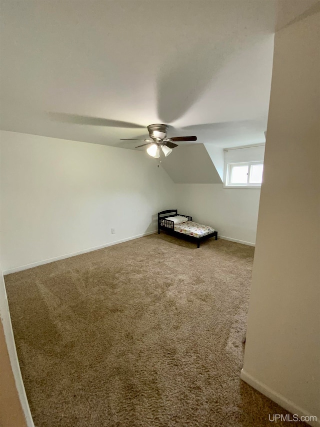 unfurnished bedroom with vaulted ceiling, carpet, and ceiling fan