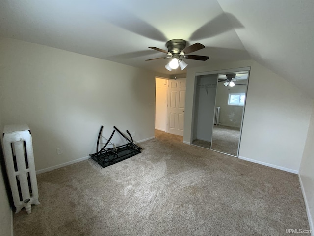 additional living space with carpet, radiator, lofted ceiling, and baseboards