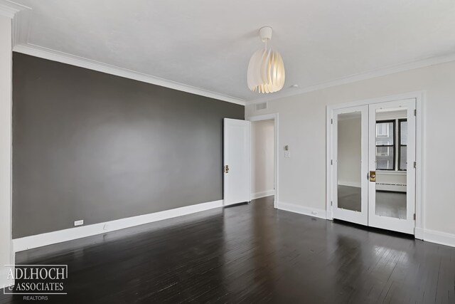 unfurnished room with ornamental molding, dark wood-type flooring, and baseboard heating